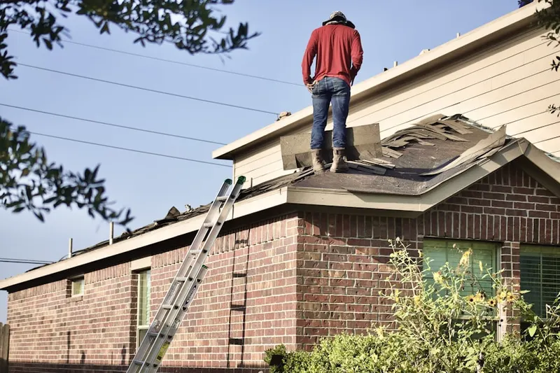 Professional roofer working on a residential roof in Fairfield Lakes